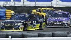 Tony Stewart, left, leads Denny Hamlin through Turn 11 during the NASCAR Sprint Cup Series auto race Sunday, June 26, 2016, in Sonoma