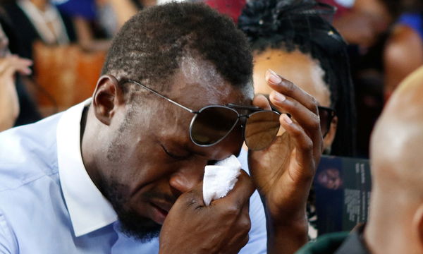 Jamaica&#8217;s Olympic champion Usain Bolt reacts during a funeral service for high jump star Germaine Mason, in Kingston