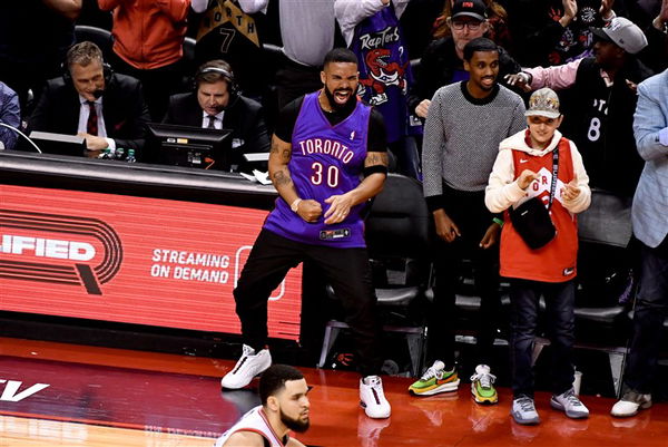 Drake and son Adonis, 5, match in leather jackets at basketball game