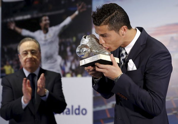 Real Madrid&#8217;s Cristiano Ronaldo kisses a trophy during a ceremony at Santiago Bernabeu stadium in Madrid