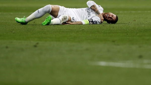 Real Madrid&#8217;s Ramos grimaces in pain during their Champions League Group A soccer match against Shakhtar Donetsk at Santiago Bernabeu stadium in Madrid