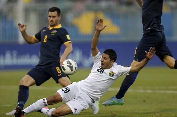 Jordan&#8217;s Hamza Aldaradreh fights for the ball with Australia&#8217;s Bailey Wright in Amman