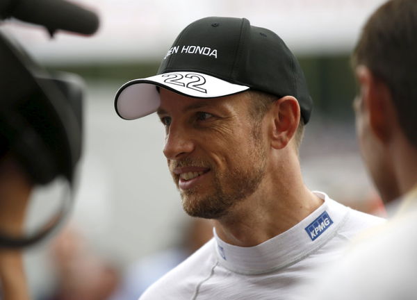 McLaren Formula One driver Jenson Button of Britain speaks to media at paddock area after the qualifying session of the Japanese F1 Grand Prix at the Suzuka Circuit in Suzuka, Japan