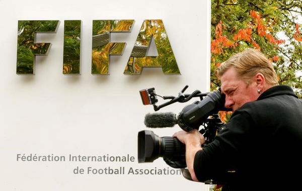 A cameraman stands in front of FIFA&#8217;s headquarters in Zurich