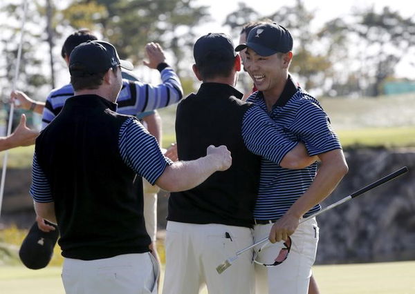 Bae of South Korea celebrates with teammates after sinking putt to defeat U.S.&#8217;s Fowler and Walker on 18th hole during four ball matches of 2015 Presidents Cup golf tournament in Incheon