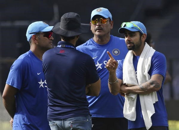 India&#8217;s Kohli talks with team selector Rathour as captain Dhoni and team director Shastri look on during a practice session ahead of their Twenty20 cricket match against South Africa in Kolkata