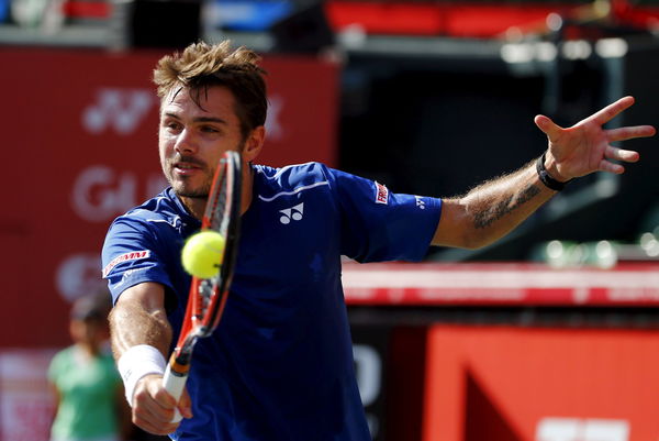 Switzerland&#8217;s Stan Wawrinka returns the ball to Austin Krajicek of the U.S.during their men&#8217;s singles tennis match at the Japan Open championships in Tokyo