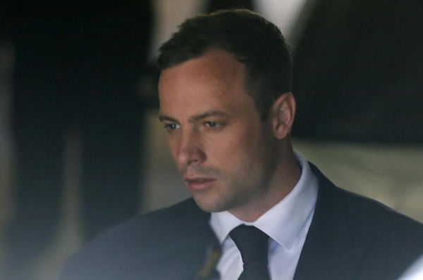 South African Olympic and Paralympic sprinter Pistorius is led to a prison van after his sentencing in Pretoria