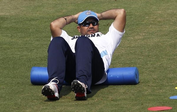 India&#8217;s Virender Sehwag stretches during a practice session ahead of their first one-day international cricket match against the West Indies in Cuttack