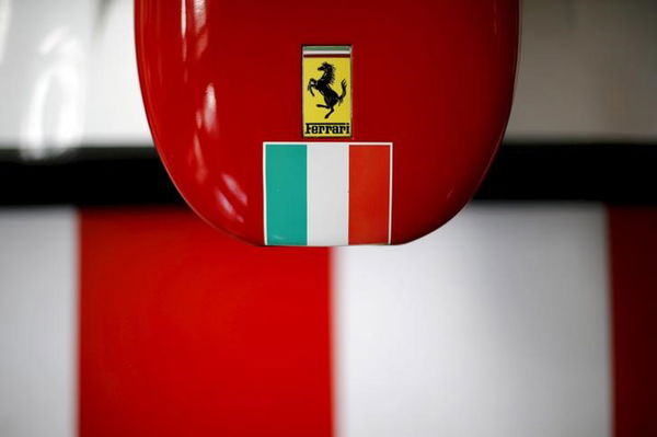 A Ferrari logo and a Italian flag are pictured on a replica of a Ferrari Formula One car in Santiago city