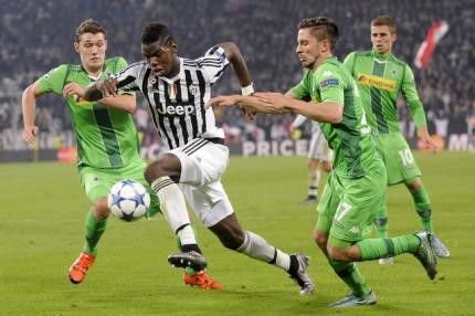 Juventus&#8217; Paul Lamine Pogba fights for the ball with Borussia Monchengladbach&#8217;s Andreas Christensen and Julian Korb during their Champions League Group D soccer match in Turin