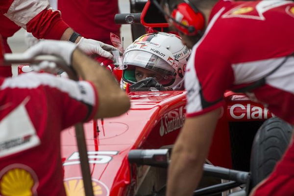 Ferrari Crew members surround Ferrari Formula One driver Sebastian Vettel of Germany in pit lane during the first practice session of the U.S. F1 Grand Prix at the Circuit of The Americas in Austin