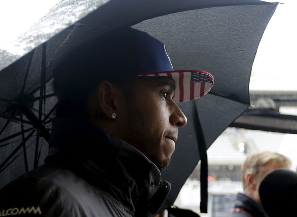 Mercedes Formula One driver Lewis Hamilton of Britain responds to a question during a rain delay before the start qualifying for the Formula One U.S. Grand Prix auto race at the Circuit of the Americas, in Austin