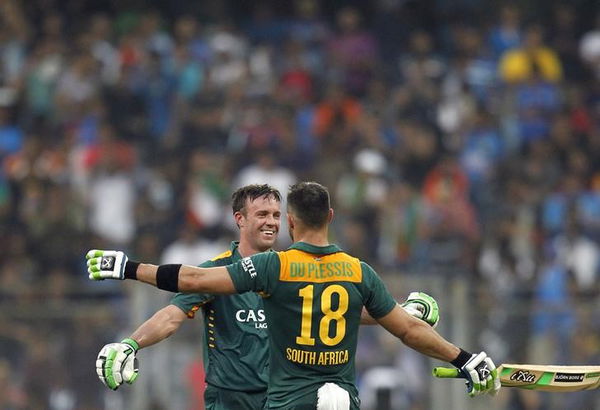 South Africa&#8217;s du Plessis celebrates scoring his century with his captain de Villiers during their fifth and final one-day international cricket match against India in Mumbai