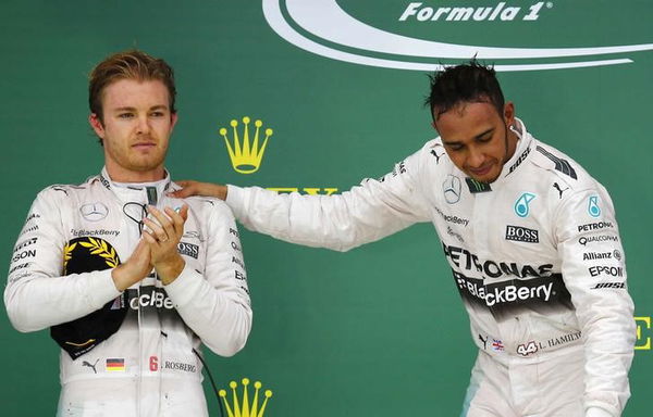 Mercedes Formula One driver Hamilton of Britain places his hand on the shoulder of teammate and second placed finisher Rosberg of Germany after Hamilton won the U.S. F1 Grand Prix at the Circuit of The Americas in Austin