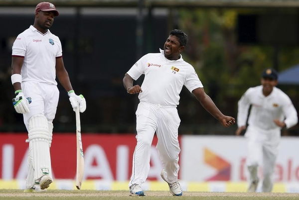 Sri Lanka&#8217;s Rangana Herath celebrates after taking the wicket of West Indies Ramdin during the final day of their second test cricket match in Colombo