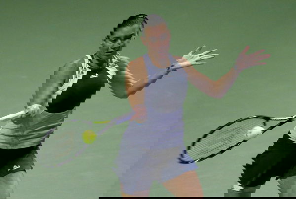 Flavia Pennetta of Italy hits a return to Maria Sharapova of Russia during their women&#8217;s singles tennis match of the WTA Finals at the Singapore Indoor Stadium