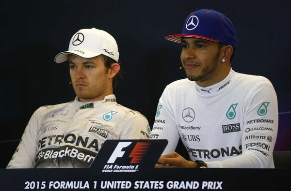 Mercedes Formula One driver Hamilton of Britain listens to a question during an after race press conference after winning the U.S. F1 Grand Prix as teammate and second placed finisher Rosberg of Germany looks on at the Circuit of The Americas in Austin