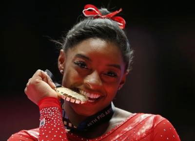 Gold medalist Simone Biles of the U.S poses with her medal after the women&#8217;s all-round final at the World Gymnastics Championships at the Hydro Arena in Glasgow