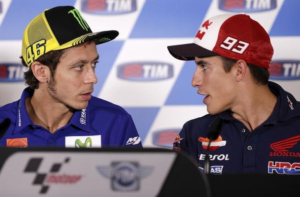 Yamaha MotoGP rider Rossi of Italy talks with Honda Marquez of Spain during a news conference for the San Marino Grand Prix in Misano Adriatico circuit in central Italy