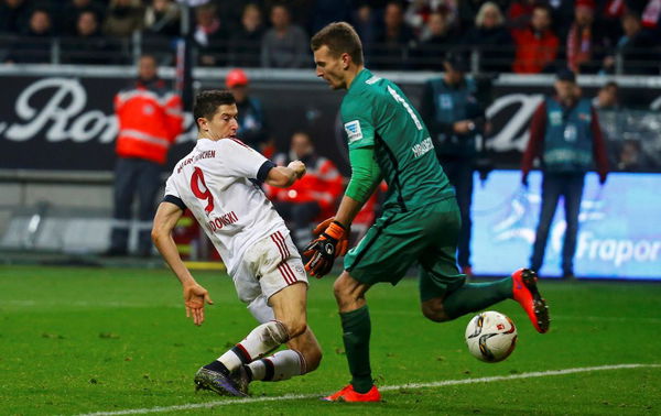 Eintracht Frankfurt&#8217;s Hradecky and Bayern Munich&#8217;s Lewandowski fight for the ball during their German first division Bundesliga soccer match in Frankfurt