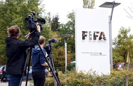 Members of the media film the FIFA logo outside their headquarters in Zurich