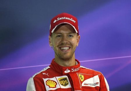 Ferrari Formula One driver Vettel of Germany smiles during the post qualifying news conference at the Singapore F1 Grand Prix