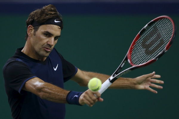 Roger Federer of Switzerland returns a shot to Albert Ramos-Vinolas of Spain during their men&#8217;s singles match at the Shanghai Masters tennis tournament in Shanghai