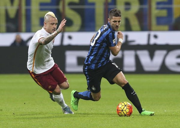 Inter Milan&#8217;s Jovetic is challenged by AS Roma&#8217;s Nainggolan during their Italian Serie A soccer match at the San Siro stadium in Milan