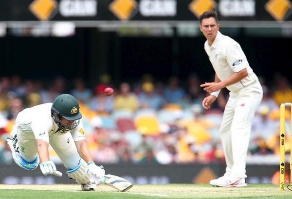 Australian batsman Joe Burns dives to make his ground, during the first cricket test match between Australia and New Zealand in Brisbane