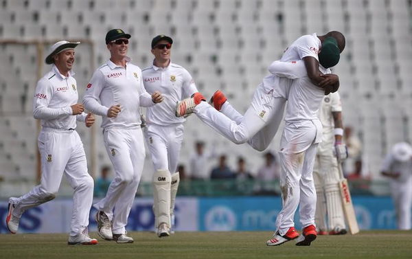 South Africa&#8217;s Rabada celebrates with teammates after dismissing India&#8217;s captain Kohli during the first day of their first cricket test match, in Mohali