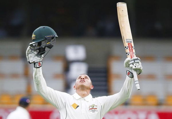 Australian batsman Usman Khawaja celebrates his maiden test century during the first cricket test match between Australia and New Zealand in Brisbane