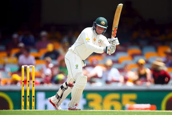 Australian batsman Usman Khawaja drives a wide delivery during the first cricket test match between Australia and New Zealand in Brisbane