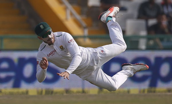 South Africa&#8217;s Plessis dives to stop the ball during the third day of their first cricket test match against India, in Mohali