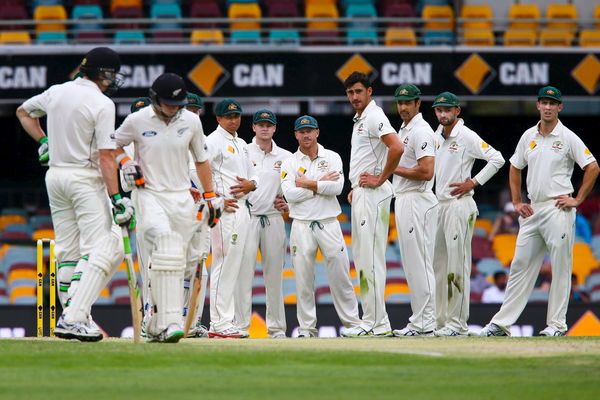 Australian players wait to see whether the New Zealand batsmen will challenge a decision with the DRS for the wicket of New Zealand batsman Tom Latham off the bowling of Mitchell Marsh, during their first cricket match in Brisbane