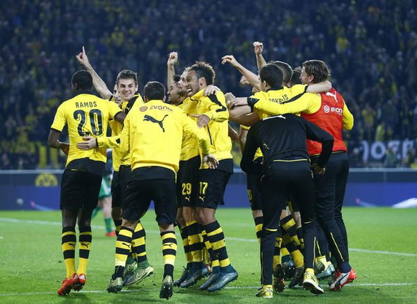 Borussia Dortmund&#8217;s players celebrate after their Bundesliga first division soccer match against Schalke 04 in Dortmund