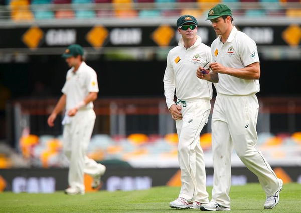 Australian captain Steven Smith talks with bowler Mitchell Johnson, during the first cricket test match between Australia and New Zealand in Brisbane