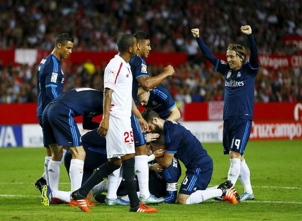 Real Madrid&#8217;s Sergio Ramos is congratulated by team mates after scoring against Sevilla during their soccer match in Seville