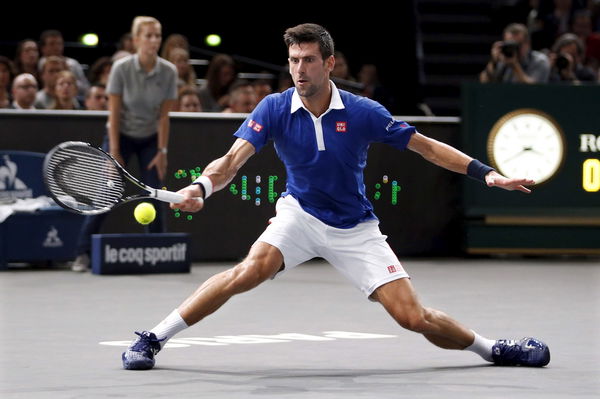 Djokovic returns to Murray during their men&#8217;s singles final tennis match at the Paris Masters tennis tournament
