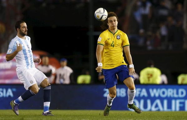 David Luiz of Brazil controls the ball next to Gonzalo Hinguain of Argentina during their 2018 World Cup qualifying soccer match in Buenos Aires,