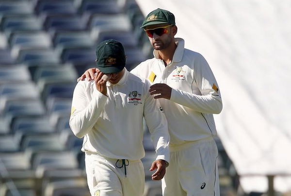 Australia&#8217;s Usman Khawaja is comforted by team mate Nathan Lyon after suffering an injury during the second day of the second cricket test match against New Zealand at the WACA ground in Perth, Western Australia