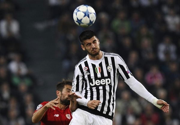 Juventus Morata jumps for the ball against Sevilla&#8217;s Coke during their Champions League group D soccer match at Juventus stadium in Turin