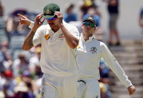 Australia&#8217;s captain Steve Smith talks with team mate Mitchell Johnson during the third day of the second cricket test match against New Zealand at the WACA ground in Perth, Western Australia