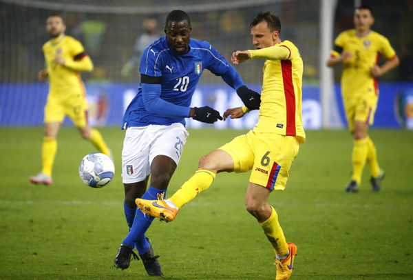 Italy&#8217;s Stefano Okaka in action against Romania&#8217;s Vlad Chiriches