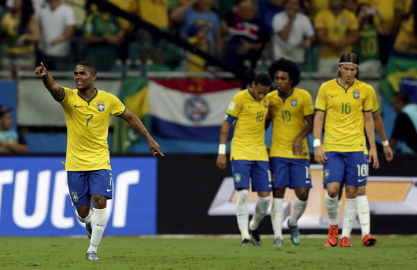 Douglas Costa of Brazil celebrates a goal against Peru next to his teammates during their 2018 World Cup qualifying soccer match in Salvador