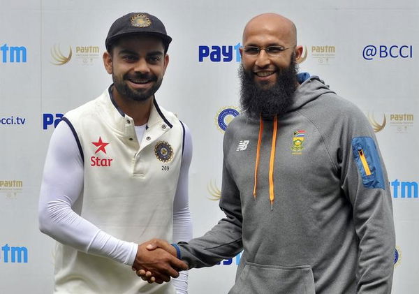 India&#8217;s captain Kohli shakes hands with the South African captain Amla after their second cricket test match was called off due to rain and wet outfield in Bengaluru