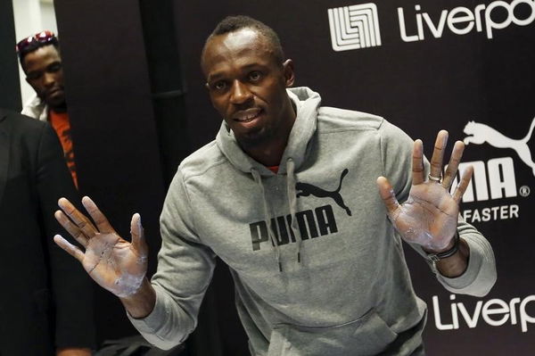 Jamaican sprinter Usain Bolt shows his hands after making hand imprints during an event arranged by his sponsors in Mexico City