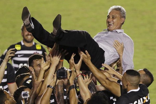 Corinthians players toss their head coach Tite as they celebrate winning the Brazil Serie A soccer championship title, following their match with Vasco, in Rio de Janeiro