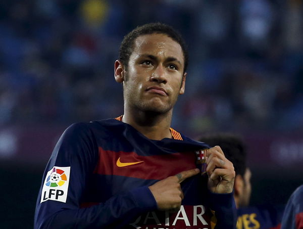 Barcelona&#8217;s Neymar points FC Barcelona logo as he celebrates a goal against Villarreal during their Spanish first division soccer match at Camp Nou stadium in Barcelona