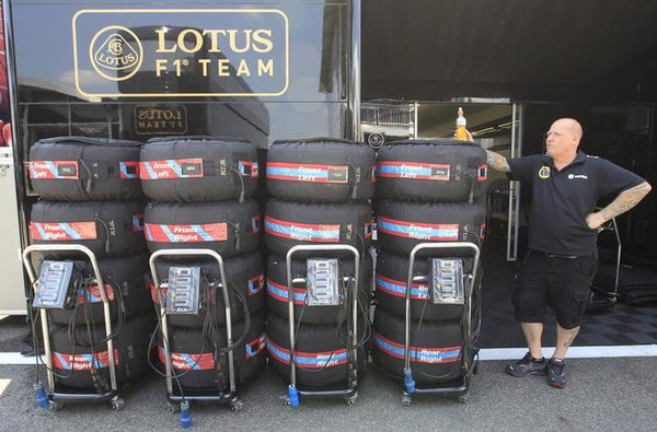 A technican stands next to a pile of tyres at Lotus Formula One team&#8217;s paddock after the first practice session of the Hungarian F1 Grand Prix at the Hungaroring circuit, near Budapest